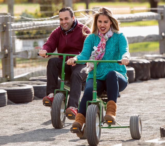 Adults enjoying the trike ride at Stony Hill Farms